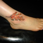 color leaf in wind ankle tattoo