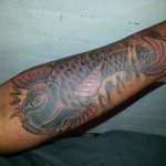 Koi fish arm tattoo cover up by Adal at Majestic Tattoo NYC