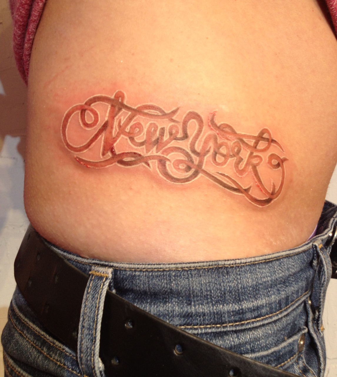 New York script tattoo with white ink