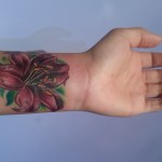 tiger lily wrist flower cover up tattoo