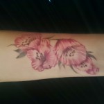 feminine floral pink forarm tattoo